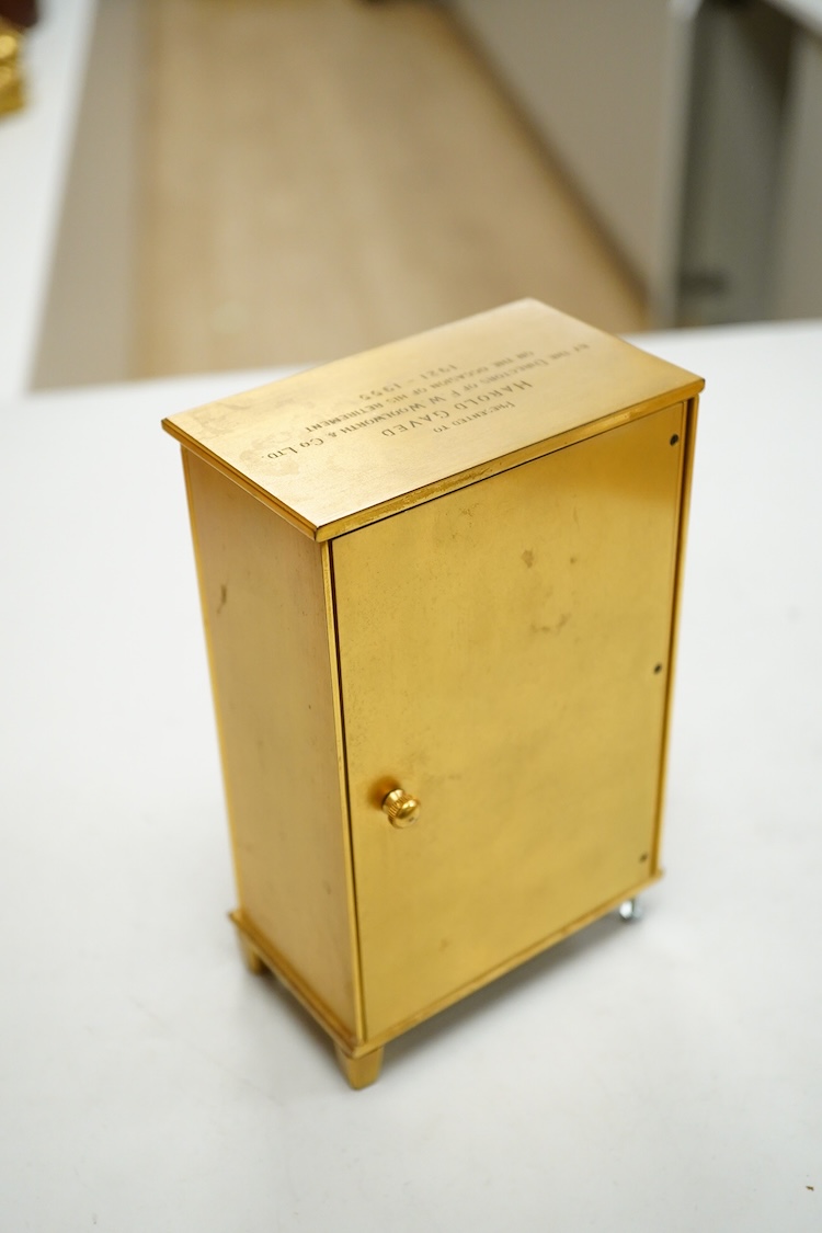 A Jaeger LeCoultre timepiece in the form of a wardrobe with pierced doors, one leg missing, 16cm high